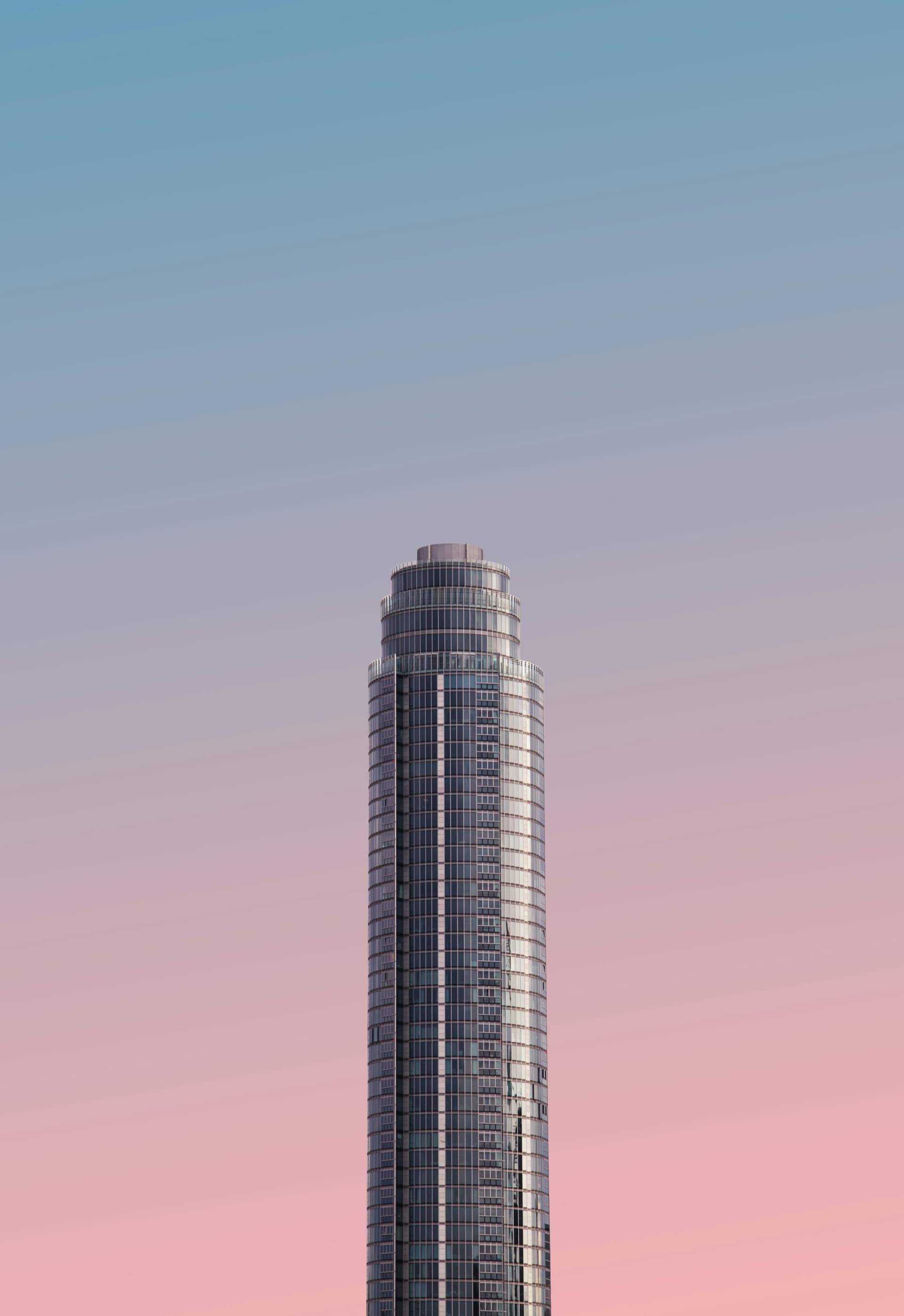 Cylindrical glass tower at sunset