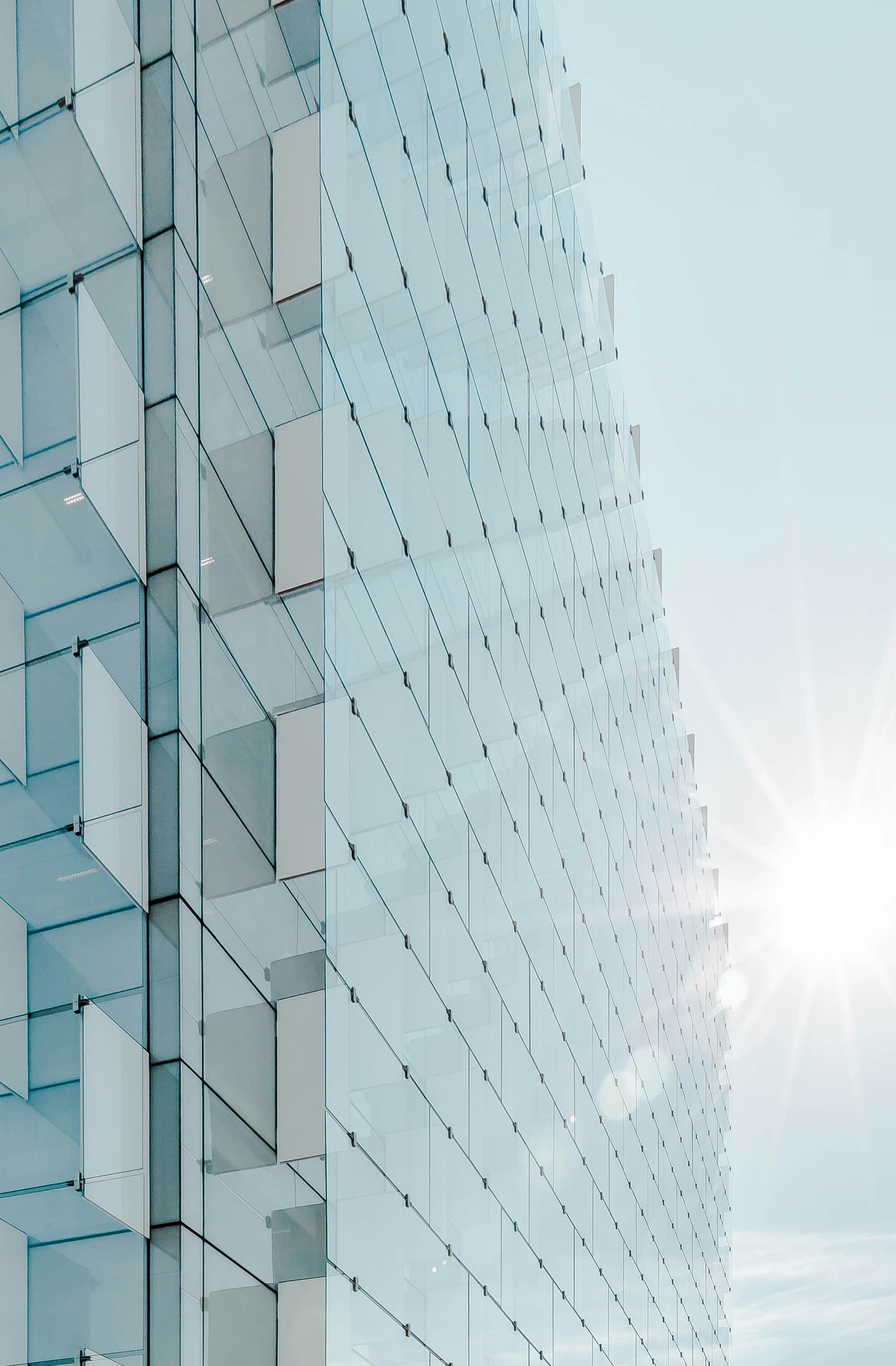 Glass building facade closeup with sun flare