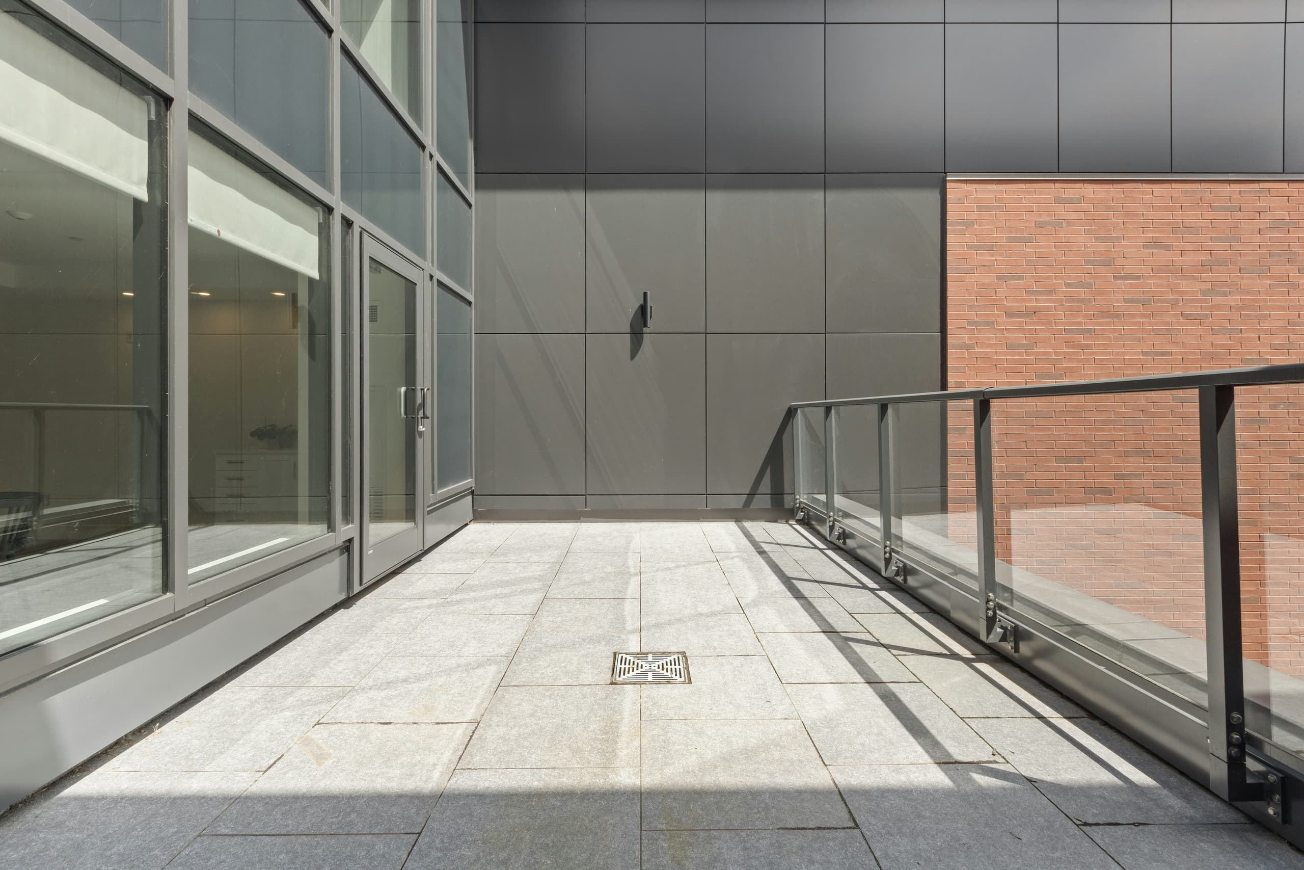 Ground-level outdoor terrace amenity at a modern office tower, the kind of space BOMA 2024 can now count as rentable