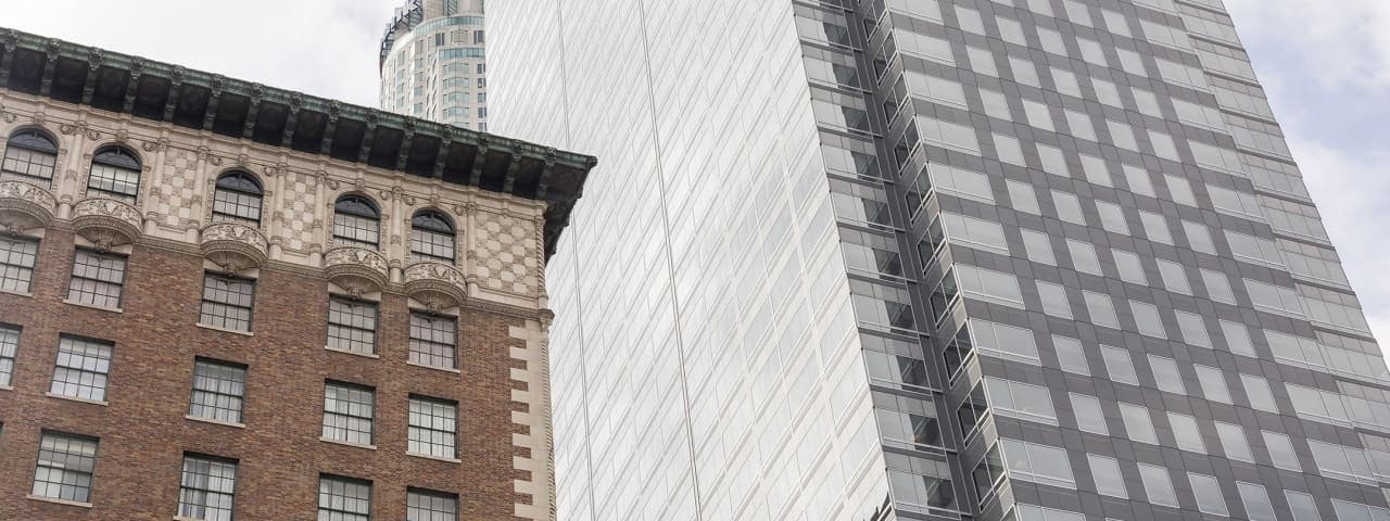 Historic and modern commercial office buildings side by side